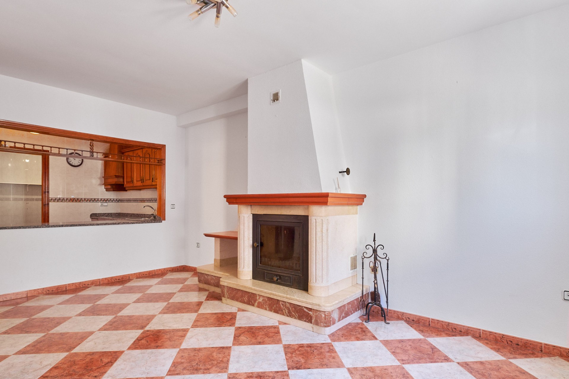 Living room with fireplace and open kitchen in villa for sale in Turre, Almería.