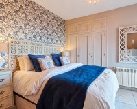 Master bedroom with fitted wardrobes and elegant décor in a villa in Sierra Cabrera, Almería.