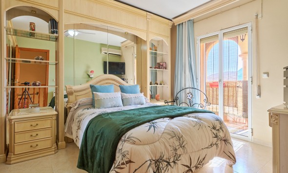  Master bedroom with fitted wardrobes, air conditioning and access to a balcony in a property for sale near Mojácar.