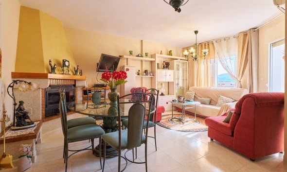  Spacious and very bright south-facing living/dining room with fireplace and glazed terrace in house for sale in Turre.